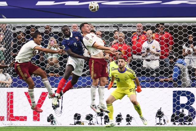 France's defender #04 Dayot Upamecano (C) fights for the ball with Spain's midfielder #16 Rodri (L) and defender #14 Aymeric Laporte during the 2026 World Cup football tournament semi-final match between France and Spain at the Dallas Stadium in Arlington on July 14, 2026.  (Photo by FRANCK FIFE / AFP)