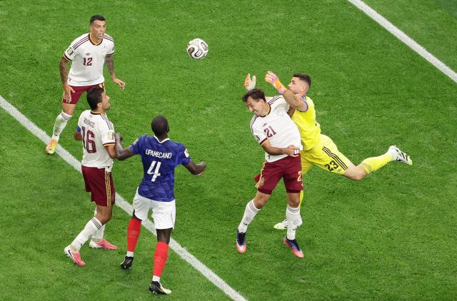 Spain's goalkeeper #23 Unai Simon (R) tussles with teammate Spain's forward #21 Mikel Oyarzabal (2R) as he comes for the ball during the 2026 World Cup football tournament semi-final match between France and Spain at the Dallas Stadium in Arlington on July 14, 2026.  (Photo by Aric Becker / AFP)