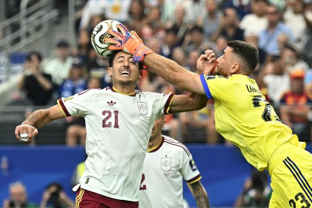 Spain's goalkeeper #23 Unai Simon tries to grab the ball as his teammate Spain's forward #21 Mikel Oyarzabal goes for a header during the 2026 World Cup football tournament semi-final match between France and Spain at the Dallas Stadium in Arlington on July 14, 2026.  (Photo by Paul ELLIS / AFP)