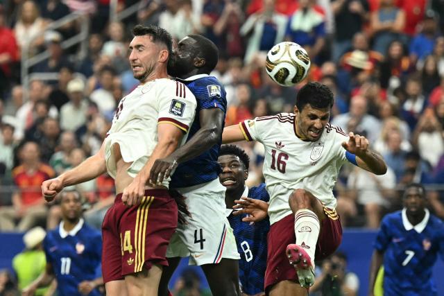 (L-R) Spain's defender #14 Aymeric Laporte, France's defender #04 Dayot Upamecano, France's midfielder #08 Aurelien Tchouameni and Spain's midfielder #16 Rodri jump for a header during the 2026 World Cup football tournament semi-final match between France and Spain at the Dallas Stadium in Arlington on July 14, 2026. (Photo by Paul ELLIS / AFP)