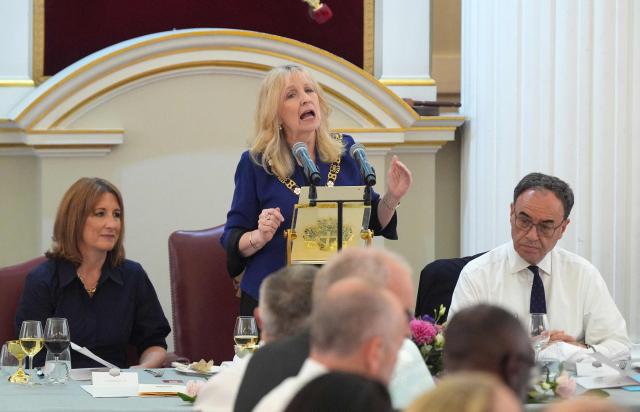 Britain's Chancellor of the Exchequer Rachel Reeves (L), and Bank of England (BoE) Governor, Andrew Bailey (R), listen as City of London Lady Mayor, Susan Langley, speaks during the annual Financial and Professional Services Dinner at Mansion House in London on July 14, 2026. (Photo by Yui Mok / POOL / AFP)