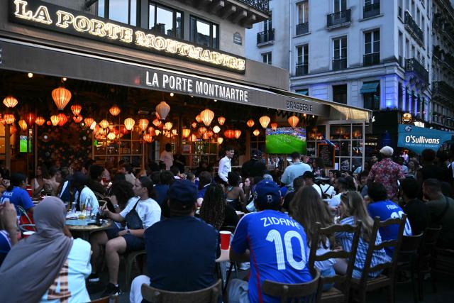 Supporters of France's football team watch the 2026 World Cup semi final football match between France and Spain at a bar in Paris on July 14, 2026. (Photo by LOU BENOIST / AFP)
