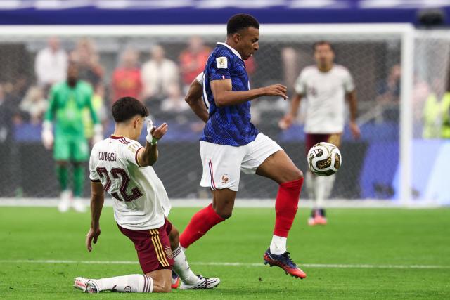 France's forward #10 Kylian Mbappe (R) controls the ball past Spain's defender #22 Pau Cubarsi during the 2026 World Cup football tournament semi-final match between France and Spain at the Dallas Stadium in Arlington on July 14, 2026.  (Photo by FRANCK FIFE / AFP)