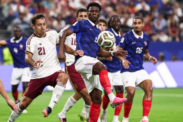 France's midfielder #08 Aurelien Tchouameni and Spain's forward #21 Mikel Oyarzabal fight for the ball during the 2026 World Cup football tournament semi-final match between France and Spain at the Dallas Stadium in Arlington on July 14, 2026.  (Photo by FRANCK FIFE / AFP)