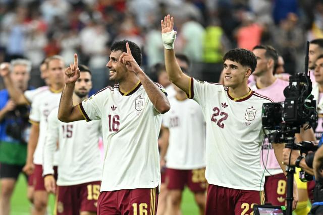 Spain's midfielder #16 Rodri and defender #22 Pau Cubarsi celebrate after their team won the 2026 World Cup football tournament semi-final match between France and Spain at the Dallas Stadium in Arlington on July 14, 2026.  (Photo by Paul ELLIS / AFP)