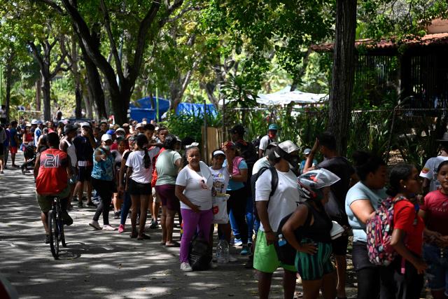 Residents queue to receive aid in Caraballeda, La Guaira state, Venezuela, on July 14, 2026, following twin earthquakes that struck the region. The death toll from the earthquakes that struck Venezuela almost three weeks ago has surpassed 4,700, while almost 17,000 people have been injured, an official report released on July 14 stated. (Photo by Federico PARRA / AFP)