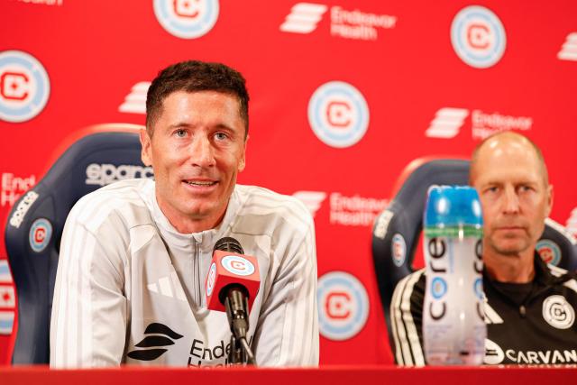 Polish forward #09 Robert Lewandowski speaks during a press conference with Chicago Fire FC head coach Gregg Berhalter as he is officially introduced as a new member of the Fire at Endeavor Health Performance Center ahead of his MLS debut in Chicago, Illinois, on July 14 2026. Poland's all-time leading goal scorer Robert Lewandowski has signed a contract through the 2027-28 campaign with the Chicago Fire, the Major League Soccer club announced in late June 2026. The 37-year-old striker arrives from Barcelona after helping the Spanish giants capture the La Liga crown last month having starred from 2014-2022 with Bayern Munich. (Photo by KAMIL KRZACZYNSKI / AFP)