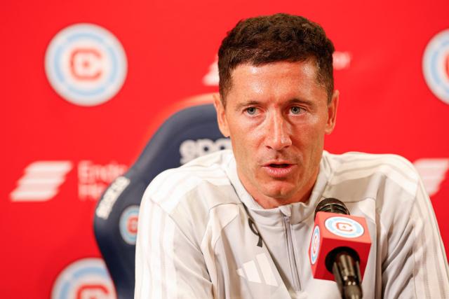 Polish forward #09 Robert Lewandowski speaks during a press conference as he is officially introduced as a new member of the Chicago Fire FC at Endeavor Health Performance Center ahead of his MLS debut in Chicago, Illinois, on July 14 2026. Poland's all-time leading goal scorer Robert Lewandowski has signed a contract through the 2027-28 campaign with the Chicago Fire, the Major League Soccer club announced in late June 2026. The 37-year-old striker arrives from Barcelona after helping the Spanish giants capture the La Liga crown last month having starred from 2014-2022 with Bayern Munich. (Photo by KAMIL KRZACZYNSKI / AFP)