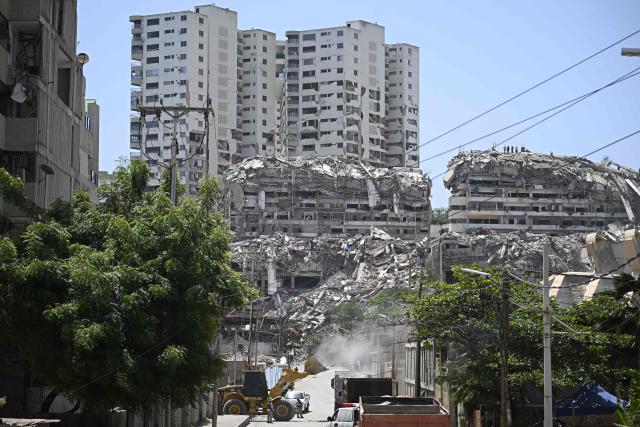 A backhoe removes debris in Catia La Mar, La Guaira state, Venezuela, on July 14, 2026, following twin earthquakes that struck the region. The death toll from the deadly earthquakes that hit Venezuela on June 14 has surpassed 4,700, while almost 17,000 people have been injured, an official report released on July 14 stated. (Photo by Federico PARRA / AFP)