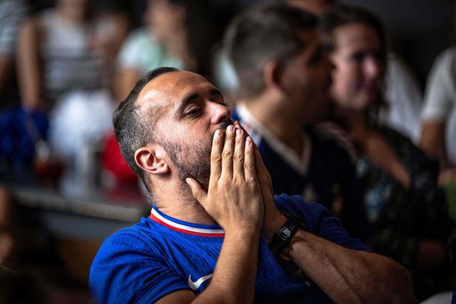 A French fan reacts while watching the FIFA World Cup semi-final match between France and Spain during an event organized by the French consulate at Robin des Bois in Lafontaine Park in Montreal, Quebec, on July 14, 2026. (Photo by ANDREJ IVANOV / AFP)