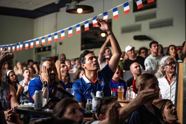 A French fan reacts while watching the FIFA World Cup semi-final match between France and Spain during an event organized by the French consulate at Robin des Bois in Lafontaine Park in Montreal, Quebec, on July 14, 2026. (Photo by ANDREJ IVANOV / AFP)