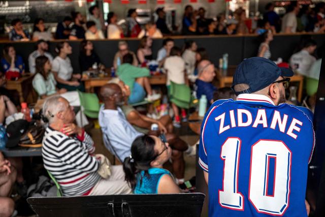 French fans watch the World Cup semi-final game between France and Spain during an event organized by the French consulate at Robin des Bois in Lafontaine Park in Montreal, Quebec, on July 14, 2026. (Photo by ANDREJ IVANOV / AFP)