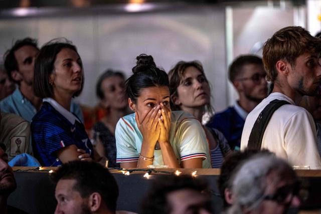 A French fan reacts while watching the World Cup semi-final game between France and Spain during an event organized by the French consulate at Robin des Bois in Lafontaine Park in Montreal, Quebec, on July 14, 2026. (Photo by ANDREJ IVANOV / AFP)