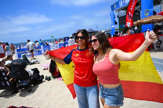 Spain fans hold a Spanish flag while watching the 2026 World Cup semi-final game between France and Spain during the LA Galaxy Soccer Celebration in Hermosa Beach, California on July 14, 2026. (Photo by Patrick T. Fallon / AFP)