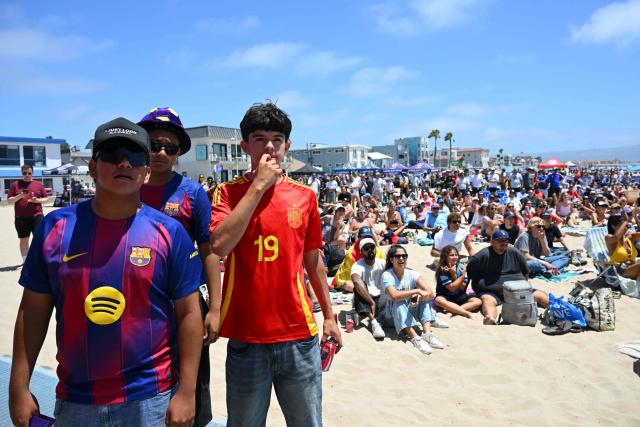 Spain fans watch the 2026 World Cup semi-final game between France and Spain during the LA Galaxy Soccer Celebration in Hermosa Beach, California on July 14, 2026. (Photo by Patrick T. Fallon / AFP)