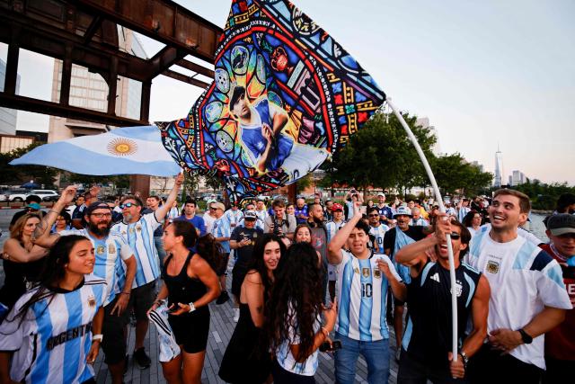 Argentina supporters wave a Maradona flag during a "Banderazo" at Little Island in New York City on July 14, 2026, on the eve of Argentina’s FIFA World Cup semifinal between Argentina and England. (Photo by Leonardo Munoz / AFP)