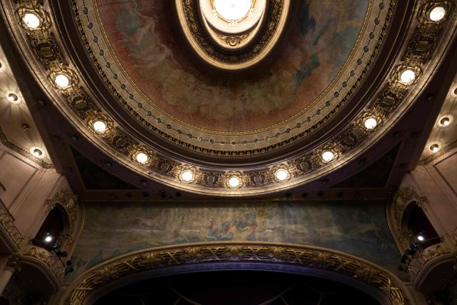 Interior view of the Theatro Municipal do Rio de Janeiro showing the ornate auditorium ceiling with a central chandelier, painted dome and decorative lighting during celebrations marking its 117th anniversary, with a series of events open to the public, on July 14, 2026, in Rio de Janeiro, Brazil. (Photo by Pablo PORCIUNCULA / AFP)