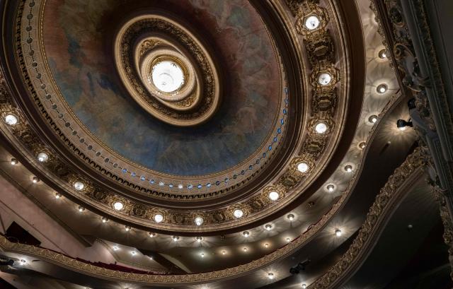 Interior view of the Theatro Municipal do Rio de Janeiro showing the ornate auditorium ceiling with a central chandelier, painted dome and decorative lighting during celebrations marking its 117th anniversary, with a series of events open to the public, on July 14, 2026, in Rio de Janeiro, Brazil. (Photo by Pablo PORCIUNCULA / AFP)