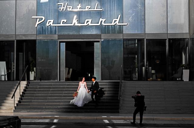 A newlywed couple poses for a photo at the Hotel Packard in Havana during a general blackout on July 14, 2026. Cuba's power grid failed for the third time in less than 10 days, sparking another nationwide blackout, the national electricity company said. (Photo by YAMIL LAGE / AFP)