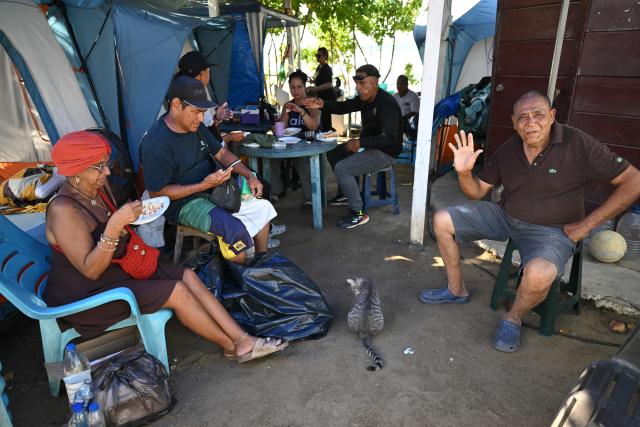 Displaced people following twin earthquakes that struck the region remain at 'Ciudad Carpita', an improvised shelter in Mare Abajo, La Guaira state, Venezuela, on July 14, 2026, . The death toll from the deadly earthquakes that hit Venezuela on June 14 has surpassed 4,700, while almost 17,000 people have been injured, an official report released on July 14 stated. (Photo by Raul ARBOLEDA / AFP)