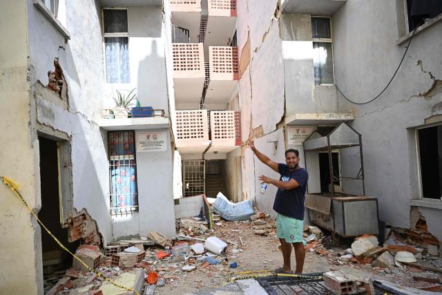 Venezuelan barber Ramon Gonzalez, 42, shows the place where he used to live, during an interview in Mare Abajo, La Guaira state, Venezuela, on July 14, 2026. The death toll from the deadly earthquakes that hit Venezuela on June 24 has surpassed 4,700, while almost 17,000 people have been injured, an official report released on July 14 stated. (Photo by Raul ARBOLEDA / AFP)