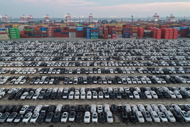 Chinese-made Volvo cars are seen alongside containers before being loaded onto ships for export at the port in Nanjing, in China’s eastern Jiangsu province on July 15, 2026. (Photo by CN-STR / AFP) / China OUT