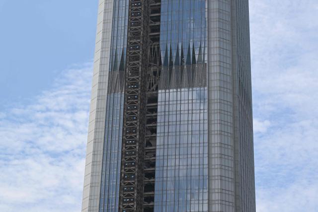 A view of a section of the under-construction Goldin Finance 117 skyscraper is seen in Tianjin on July 14, 2026. The world's tallest unoccupied skyscraper was meant to boast a rooftop swimming pool and a luxury hotel once completed, but instead it has stood deserted in the Chinese port city of Tianjin for years. Work on the soaring Goldin Finance 117 began in 2008, but construction stalled as its developer fell into debt, and the tower remains unfinished 18 years on. (Photo by ADEK BERRY / AFP)