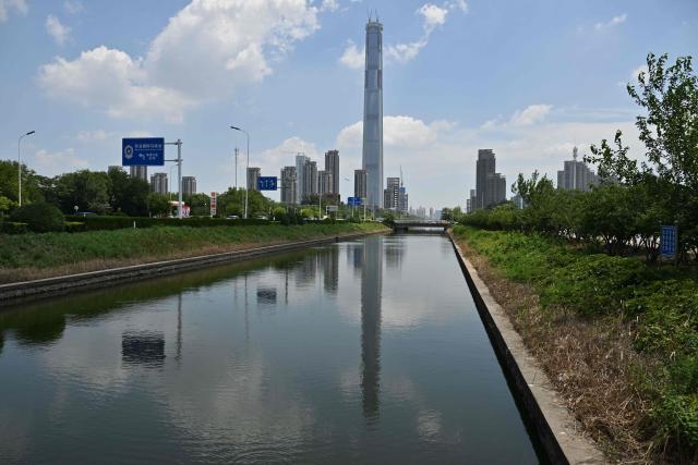 A view of the under-construction Goldin Finance 117 skyscraper is seen in Tianjin on July 14, 2026. The world's tallest unoccupied skyscraper was meant to boast a rooftop swimming pool and a luxury hotel once completed, but instead it has stood deserted in the Chinese port city of Tianjin for years. Work on the soaring Goldin Finance 117 began in 2008, but construction stalled as its developer fell into debt, and the tower remains unfinished 18 years on. (Photo by ADEK BERRY / AFP)