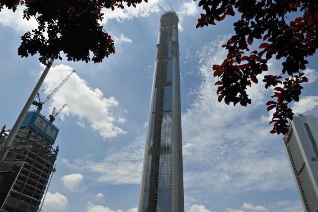 A view of the under-construction Goldin Finance 117 skyscraper is seen in Tianjin on July 14, 2026. The world's tallest unoccupied skyscraper was meant to boast a rooftop swimming pool and a luxury hotel once completed, but instead it has stood deserted in the Chinese port city of Tianjin for years. Work on the soaring Goldin Finance 117 began in 2008, but construction stalled as its developer fell into debt, and the tower remains unfinished 18 years on. (Photo by ADEK BERRY / AFP)