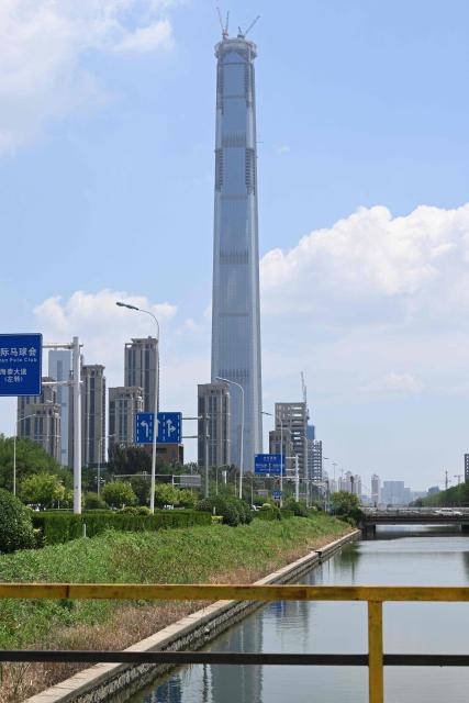 A view of the under-construction Goldin Finance 117 skyscraper is seen in Tianjin on July 14, 2026. The world's tallest unoccupied skyscraper was meant to boast a rooftop swimming pool and a luxury hotel once completed, but instead it has stood deserted in the Chinese port city of Tianjin for years. Work on the soaring Goldin Finance 117 began in 2008, but construction stalled as its developer fell into debt, and the tower remains unfinished 18 years on. (Photo by ADEK BERRY / AFP)
