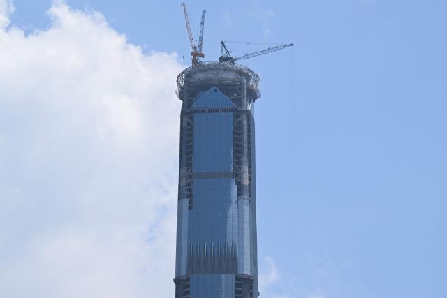 A view of the under-construction Goldin Finance 117 skyscraper is seen in Tianjin on July 14, 2026. The world's tallest unoccupied skyscraper was meant to boast a rooftop swimming pool and a luxury hotel once completed, but instead it has stood deserted in the Chinese port city of Tianjin for years. Work on the soaring Goldin Finance 117 began in 2008, but construction stalled as its developer fell into debt, and the tower remains unfinished 18 years on. (Photo by ADEK BERRY / AFP)