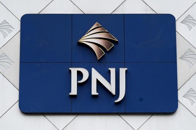 The logo of the Phu Nhuan Jewelry (PNJ) group is displayed at the storefront of a shop in Hanoi on July 15, 2026. Police in Vietnam are investigating an international diamond ring accused of smuggling in 28,000 diamonds worth nearly $11 million, with the country's largest jeweller Phu Nhuan Jewelry (PNJ) caught up in the probe. (Photo by Nhac NGUYEN / AFP)