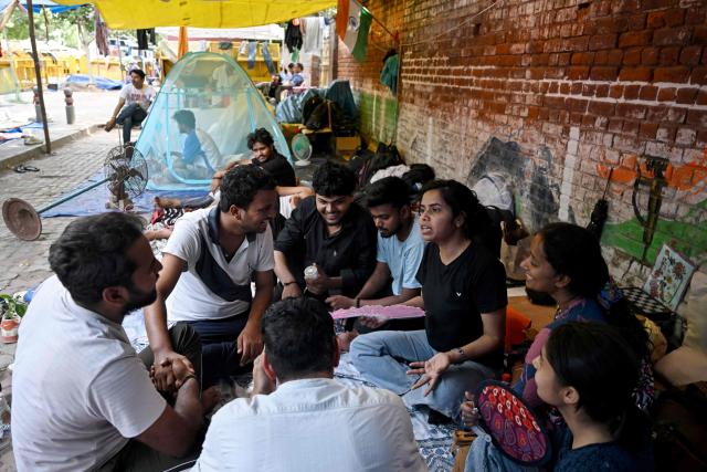 Cockroach Janta Party (CJP) supporters take part in a hunger strike during a sit-in protest in New Delhi on July 15, 2026, to demand the resignation of India’s Education Minister Dharmendra Pradhan over alleged examination irregularities. (Photo by Arun SANKAR / AFP)