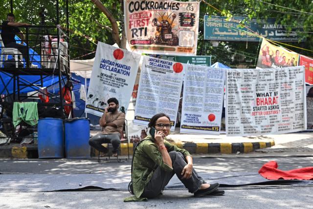 Cockroach Janta Party (CJP) supporters rest next to banners during a sit-in protest in New Delhi on July 15, 2026, to demand the resignation of India’s Education Minister Dharmendra Pradhan over alleged examination irregularities. (Photo by Arun SANKAR / AFP)