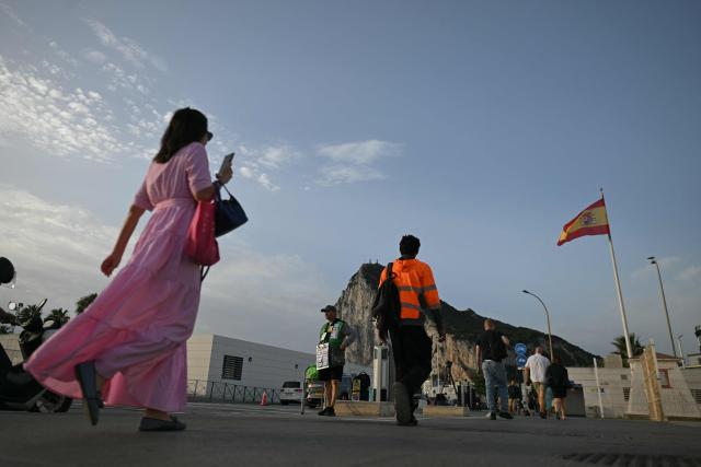 People walk from La Linea de la Concepcion, Spain into the British territory of Gibraltar for the first time without border controls on July 15, 2026. A new era began between Spain and the tiny British territory of Gibraltar on Wednesday, as border checks that have long been a source of tension and frustration were finally lifted. (Photo by JORGE GUERRERO / AFP)