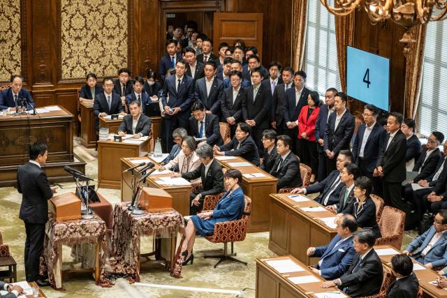 Japan's Prime Minister Sanae Takaichi (bottom C) attends the joint meeting of the committees of both houses on fundamental national policies at the National Diet in Tokyo on July 15, 2026. (Photo by Yuichi YAMAZAKI / AFP)