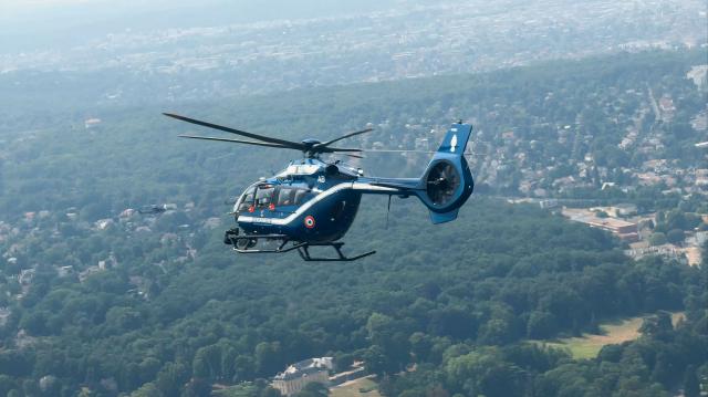 This frame grab from an AFP TV video shows the new helicopter H145 D3 of the French gendarmerie flies over Paris during the annual Bastille Day military parade, on July 14, 2026. The H145 D3, has been in service for the past five months and its performance is enhanced by innovative technological features such as optronics sensors, reinforced ballistic protection and a secure data transmission system. Two helicopters of this type were funded by the British via the Sandhurst Fund, as part of the Sandhurst Cooperation Treaty between France and the United Kingdom, aimed at curbing illegal crossings of the English Channel. This treaty was signed on January 18, 2018 during the 35th Franco-British summit. A second helicopter has been delivered to Amiens. Four more are due to be delivered by 2028. (Photo by Benoît DUCROCQ / AFP)