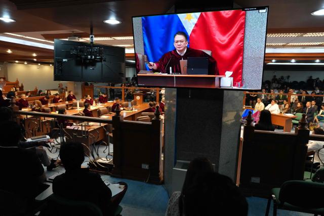 Senate Presiding Officer Francis Escudero is seen on a screen as he bangs the gavel at the session hall during the impeachment trial for Philippine Vice President Sara Duterte at the Philippine Senate in Pasay city on July 15, 2026.  (Photo by Aaron Favila / POOL / AFP)