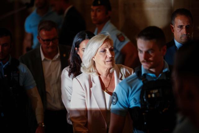 (FILES) President of Rassemblement National parliamentary group Marine Le Pen (L) leaves after the verdict in the appeal trial of RN former or actual members on charges of embezzlement of European public funds in a case of alleged European Parliament fake jobs at Paris Court of Appeal on July 7, 2026. The Office of the Prosecutor General at the Paris Court of Appeal announced on July 15, 2026 that it had decided not to file an appeal with the Court of Cassation in the case involving the French far-right party, then Front National (FN), now Rassemblement National (RN), parliamentary assistants to Members of the European Parliament, "following a thorough review of the judgment handed down on July 7." Marine Le Pen, for her part, said last week that she would appeal to the Court of Cassation. Her appeal therefore suspends the enforcement of her one-year prison sentence, which was to be served under home detention with electronic monitoring (an ankle bracelet), pending the court's ruling. (Photo by Dimitar DILKOFF / AFP)