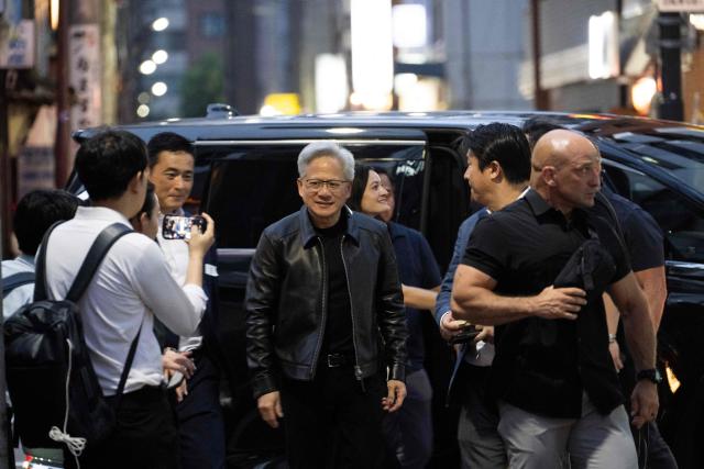 Nvidia CEO Jensen Huang (C) arrives at a restaurant with guests in Tokyo on July 15, 2026. (Photo by Andrew CABALLERO-REYNOLDS / AFP)