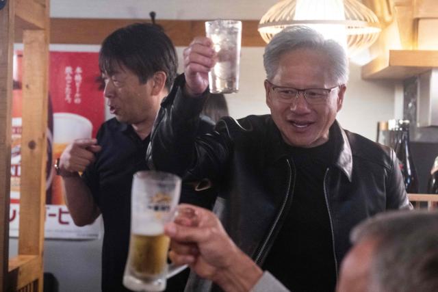Nvidia CEO Jensen Huang (C) speaks after giving a toast to his guests inside a restaurant in Tokyo on July 15, 2026. (Photo by Andrew CABALLERO-REYNOLDS / AFP)