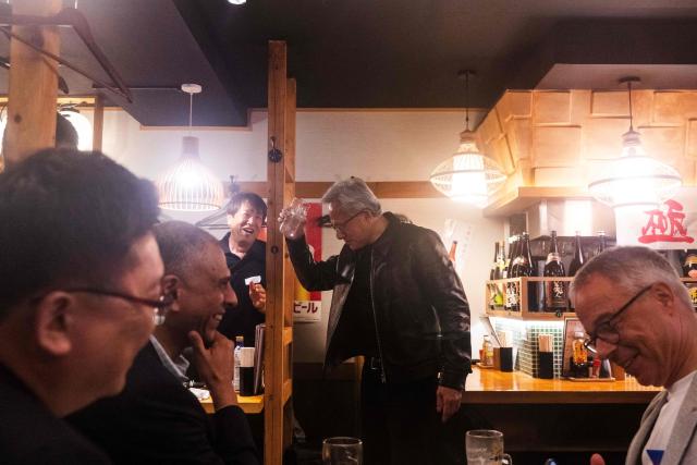 Nvidia CEO Jensen Huang (C) gestures after giving a toast to his guests inside a restaurant in Tokyo on July 15, 2026. (Photo by Andrew CABALLERO-REYNOLDS / AFP)