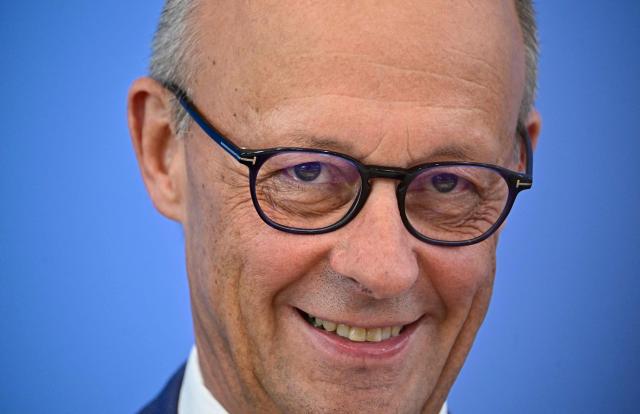 German Chancellor Friedrich Merz smiles as he addresses journalists during his summer press conference in Berlin, Germany, on July 15, 2026. (Photo by Tobias SCHWARZ / AFP)