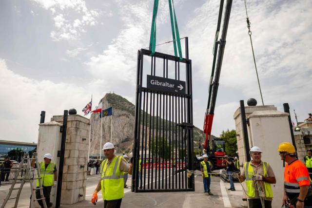 Workers dismantle the border fence between Spain and the British overseas territory of Gibraltar at the  border crossing in La Linea de la Concepcion, southern Spain, on July 15, 2026. A new era began between Spain and the tiny British territory of Gibraltar on July 15, 2026, as border checks that have long been a source of tension and frustration were finally lifted after the signing of a post-Brexit deal in Brussels between the UK, Spain, Gibraltar and the EU. (Photo by JORGE GUERRERO / AFP)