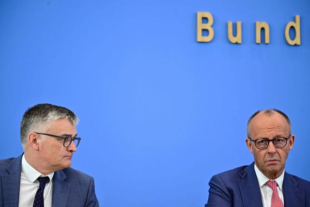German Chancellor Friedrich Merz (R) sits next to the German government's spokesperson Stefan Kornelius as he addresses journalists during his summer press conference in Berlin, Germany, on July 15, 2026. (Photo by Tobias SCHWARZ / AFP)