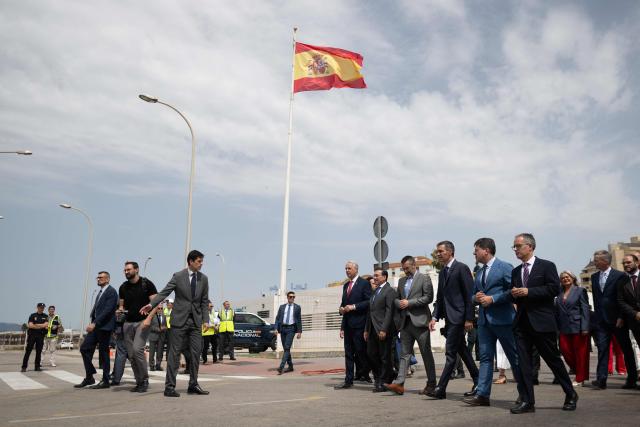 Spain's Prime Minister Pedro Sanchez (3R) and Chief Minister of Gibraltar Fabian Picardo (2L) and other authorities walk during a ceremony ending border controls between Spain and the British overseas territory of Gibraltar at the  border crossing in La Linea de la Concepcion, southern Spain, on July 15, 2026. A new era began between Spain and the tiny British territory of Gibraltar on July 15, 2026, as border checks that have long been a source of tension and frustration were finally lifted after the signing of a post-Brexit deal in Brussels between the UK, Spain, Gibraltar and the EU. (Photo by JORGE GUERRERO / AFP)