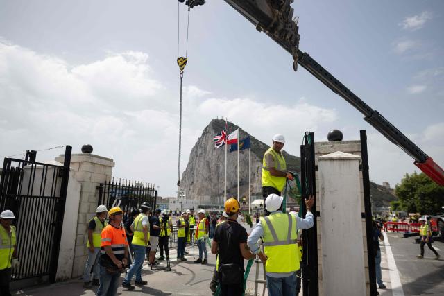 Workers dismantle the border fence between Spain and the British overseas territory of Gibraltar at the  border crossing in La Linea de la Concepcion, southern Spain, on July 15, 2026. A new era began between Spain and the tiny British territory of Gibraltar on July 15, 2026, as border checks that have long been a source of tension and frustration were finally lifted after the signing of a post-Brexit deal in Brussels between the UK, Spain, Gibraltar and the EU. (Photo by JORGE GUERRERO / AFP)