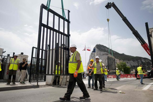 Workers dismantle the border fence between Spain and the British overseas territory of Gibraltar at the  border crossing in La Linea de la Concepcion, southern Spain, on July 15, 2026. A new era began between Spain and the tiny British territory of Gibraltar on July 15, 2026, as border checks that have long been a source of tension and frustration were finally lifted after the signing of a post-Brexit deal in Brussels between the UK, Spain, Gibraltar and the EU. (Photo by JORGE GUERRERO / AFP)