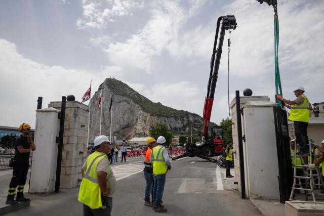 Workers dismantle the border fence between Spain and the British overseas territory of Gibraltar at the  border crossing in La Linea de la Concepcion, southern Spain, on July 15, 2026. A new era began between Spain and the tiny British territory of Gibraltar on July 15, 2026, as border checks that have long been a source of tension and frustration were finally lifted after the signing of a post-Brexit deal in Brussels between the UK, Spain, Gibraltar and the EU. (Photo by JORGE GUERRERO / AFP)