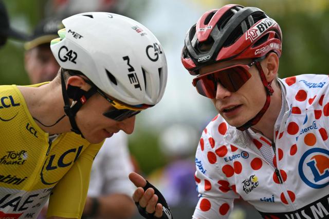 UAE Team Emirates - XRG's Slovenian rider Tadej Pogacar wearing the overall leader's yellow jersey speaks with Team Visma | Lease a Bike's Danish rider Jonas Vingegaard wearing the climber's dotted "King of the Mountains" jersey at the start of the 11th stage of the 113th edition of the Tour de France cycling race, 161,3 km between Vichy and Nevers in central France, on July 15, 2026. (Photo by Jeff PACHOUD / AFP)